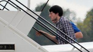 Jeremy Forrest being escorted onto a plane to Britain after being extradited from France