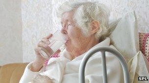 Elderly woman drinking water