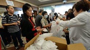 People queuing up to buy face masks in Singapore