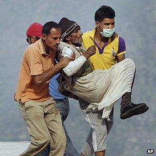 An elderly Indian man is evacuated from a flooded area. Photo: 21 June 2013