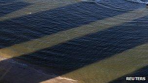 Shadows of buildings on the sea