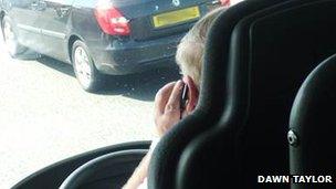 Photo taken of driver appearing to use mobile phone at the wheel