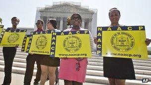 Supporters of the Voting Rights Act demonstrate outside the US Supreme Court in Washington DC on 25 June 2013