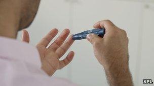 Man testing blood sugar levels