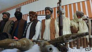 Former Taliban fighters stand in front of the media after joining Afghan government forces during a ceremony in Herat on on 26 June 2013