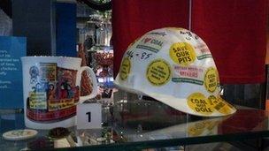 A miner's helmet covered in stickers