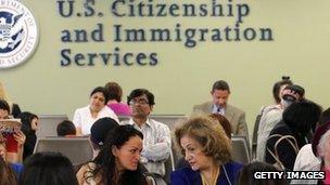 Immigrants await their turn for green card and citizenship interviews at the US Citizenship and Immigration Services (USCIS) office in Queens, New York City 30 May 2013