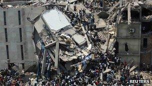 Crowds trying to rescue garment workers trapped under rubble at the Rana Plaza building after it collapsed on 24 April