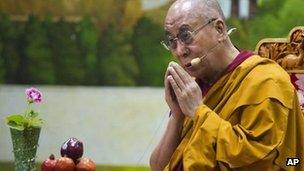 Tibetan spiritual leader the Dalai Lama prays during a talk to young Tibetans at the Tibetan Children's Village School in Dharamsala, India, Thursday, June 27, 2013