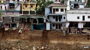 Damaged houses above the flash flood-eroded Mandakini river in the town of Tilwara, around 30kms from Rudraprayag