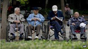 File photo: a group of elderly men take a rest on their wheelchairs at a park in Beijing on 23 May 2013