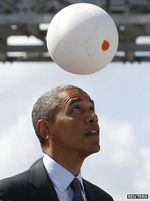 US President Barack Obama heads a "soccet ball" at Ubungo Power Plant in Dar es Salaam on 2 July 2013