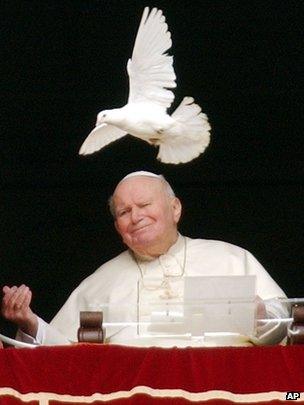 Pope John Paul II looks at a white dove freed at the end of the Angelus prayer in St Peter's Square, Vatican, 30 January 2005