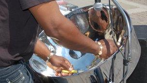 Jamma, from Birmingham, busking with a steel pan in Gloucester