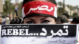 Protester holds up a Tamarod petition in Cairo (17 June 2013)