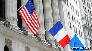 US, French and EU flags at the New York Stock Exchange