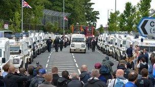 Orange Order marchers make their way past Ardoyne in Belfast last July