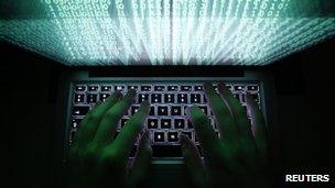 File photo: a man typing at a computer keyboard