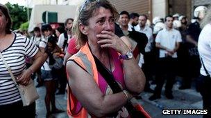 A woman cries during a demonstration of municipal workers in front of the Interior ministry in Athens on July 8, 2013.