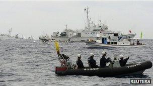 File photo: Japanese Coast Guard vessels, Japanese fishing boats, and a Chinese surveillance ship in the East China Sea near the disputed islands, known as Senkaku in Japan and Diaoyu in China, 26 May 2013