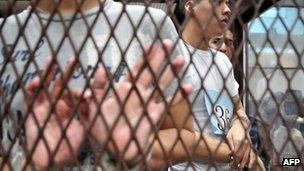 Suspected members of the Zetas cartel wait in court in Guatemala City on June 27, 2012