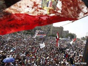 Blood-stained Egyptian flag at a protest in Cairo (8 July 2013)