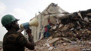 Man in front of collapsed building