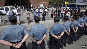 Police and reporters outside the federal courthouse in Boston, Massachusetts 10 July 2013