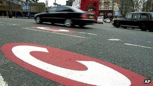 A car drives past a congestion charge mark on a London road