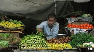 In this photograph taken on June 16, 2011 an Indian vendor waits for customers at his roadside vegetable shop in Mumbai.