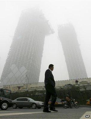 Man walking along a polluted street (Image: AP)