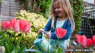 A girl watering flowers