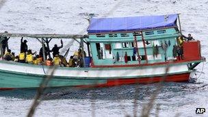 File photo: a fishing boat carrying Vietnamese asylum seekers nears the shore of Australia"s Christmas Island on 14 April 2013