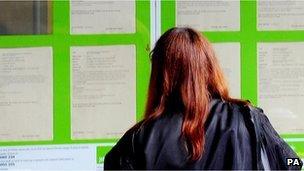 Young woman looking a job vacancies board