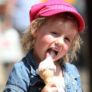 A young girl enjoys a cooling treat