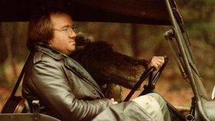 Mel Smith driving a jeep on a production set