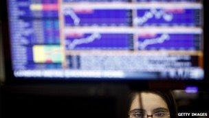 woman sitting in front of trading screen