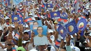 This photo taken on 19 July 2013 shows supporters of the Cambodia National Rescue Party (CNRP) holding portrait photos of Sam Rainsy at the Democracy Park in Phnom Penh