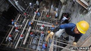 Worker climbs out of an underground construction site in Hefei, China