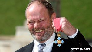 John Lloyd collecting his CBE