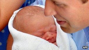 Prince George of Cambridge cradled by his father, the Duke of Cambridge