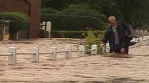 Man walking through flood