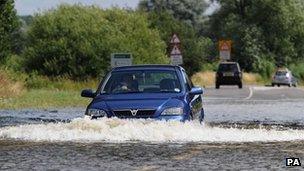 Car drives through flood water in Loughborough on 28 July 2013