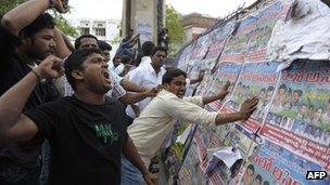 Indian students of the Telangana Joint Action Committee (T-JAC) shout slogans and attack barricades as police prevent the students from marching to the "Assembly" during a pro-Telangana protest in Hyderabad on June 13, 2013