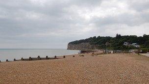 Shingle beach at Pett Level looking towards Fairlight which behind the cliffs at Cliff End