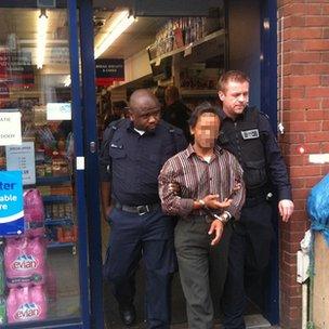 UK Border Agency officers arrest a suspected illegal worker