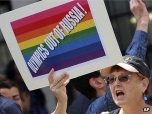 A gay rights activist holds up a placard during a demonstration in front of the Russian consulate in New York on 31 July