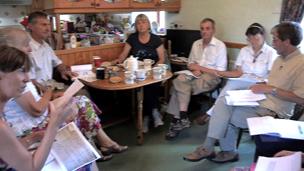 Volunteers discuss the results of their transcription work