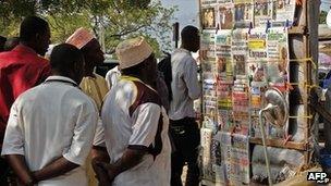 People looking at headlines in Zanzibar