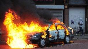 A car on fire in Belfast city centre during the disturbances